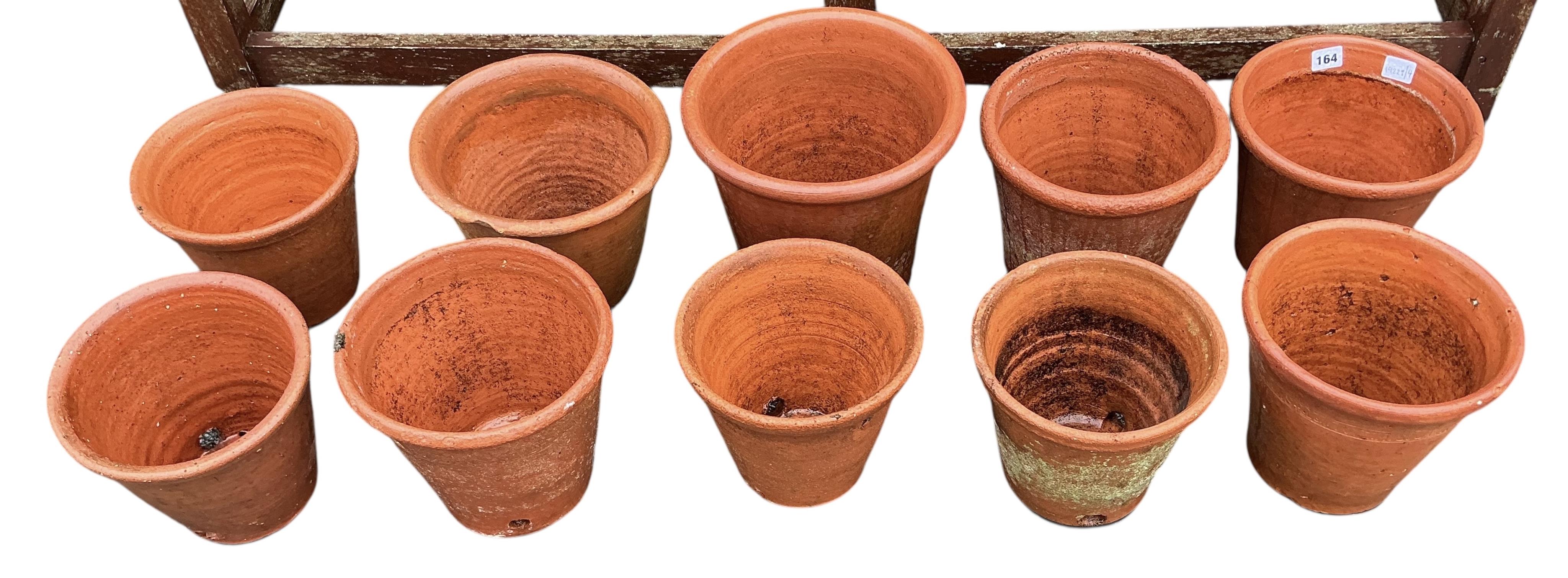 Ten assorted circular terracotta garden pots, largest diameter 28cm, height 25cm